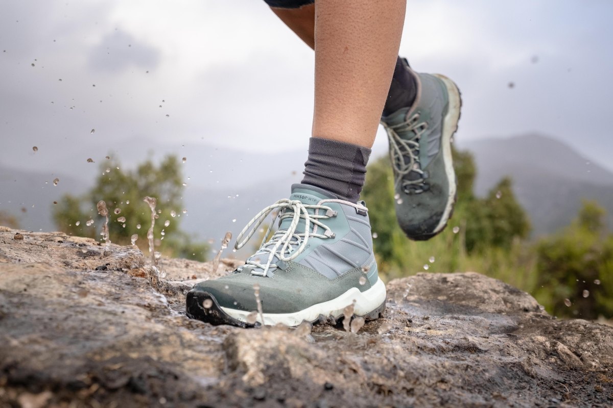Woman wearing waterproof hiking boots rain