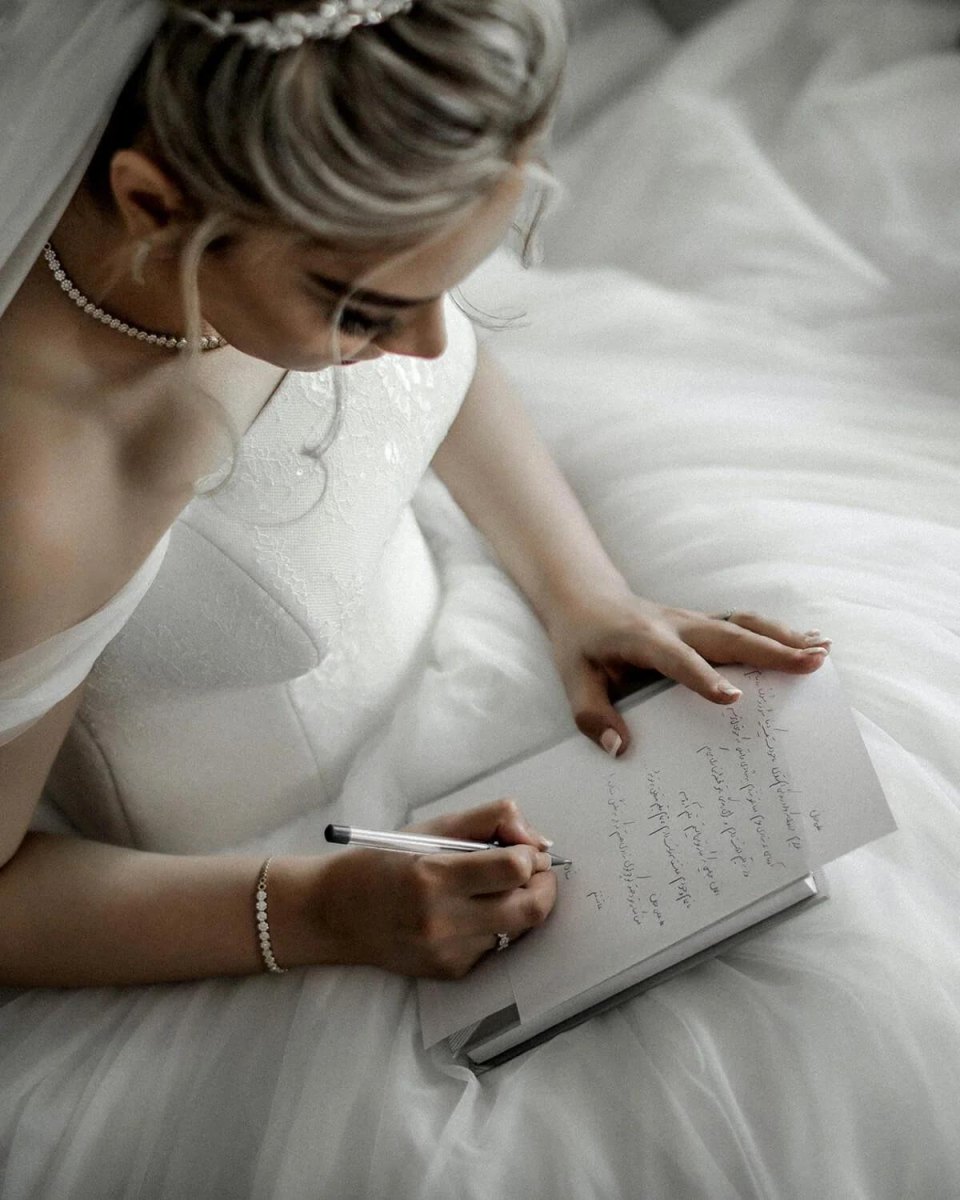 Writing wedding vows in notebook