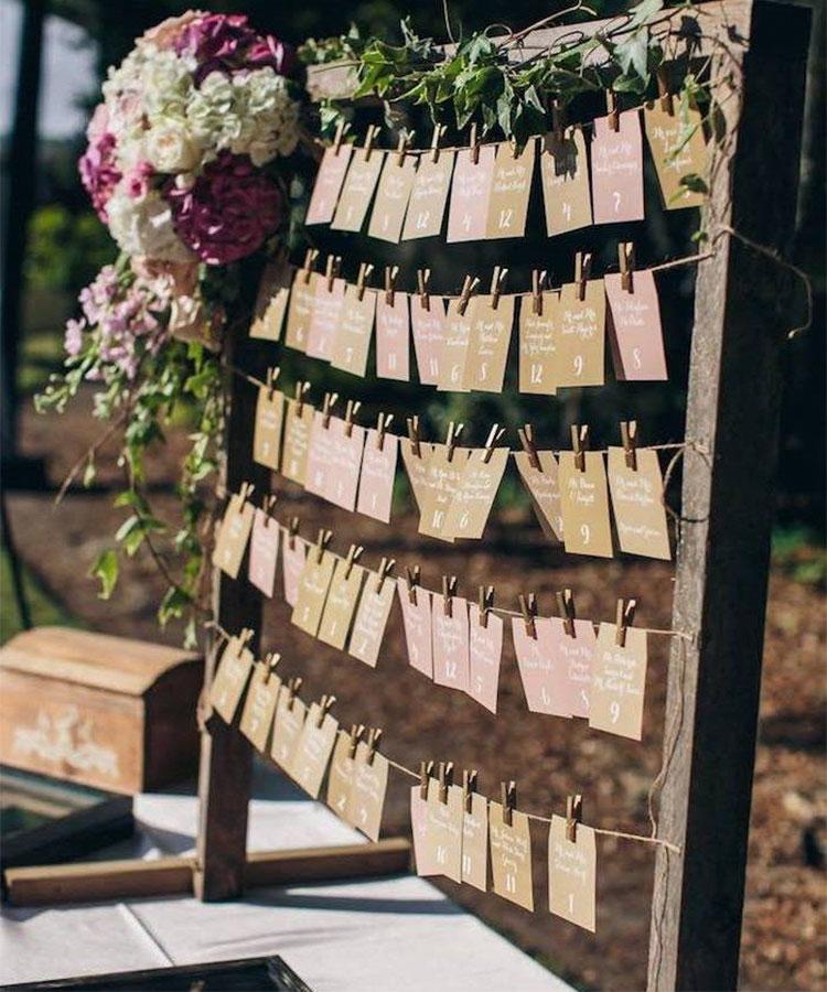 Creative DIY wedding seating chart display with hanging cards
