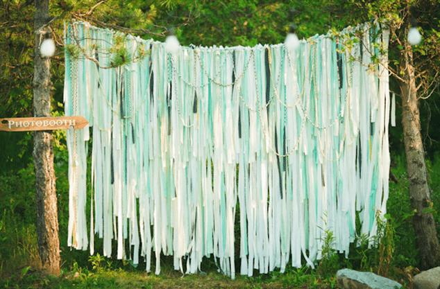 DIY wedding photo booth backdrop with hanging fabric decorations