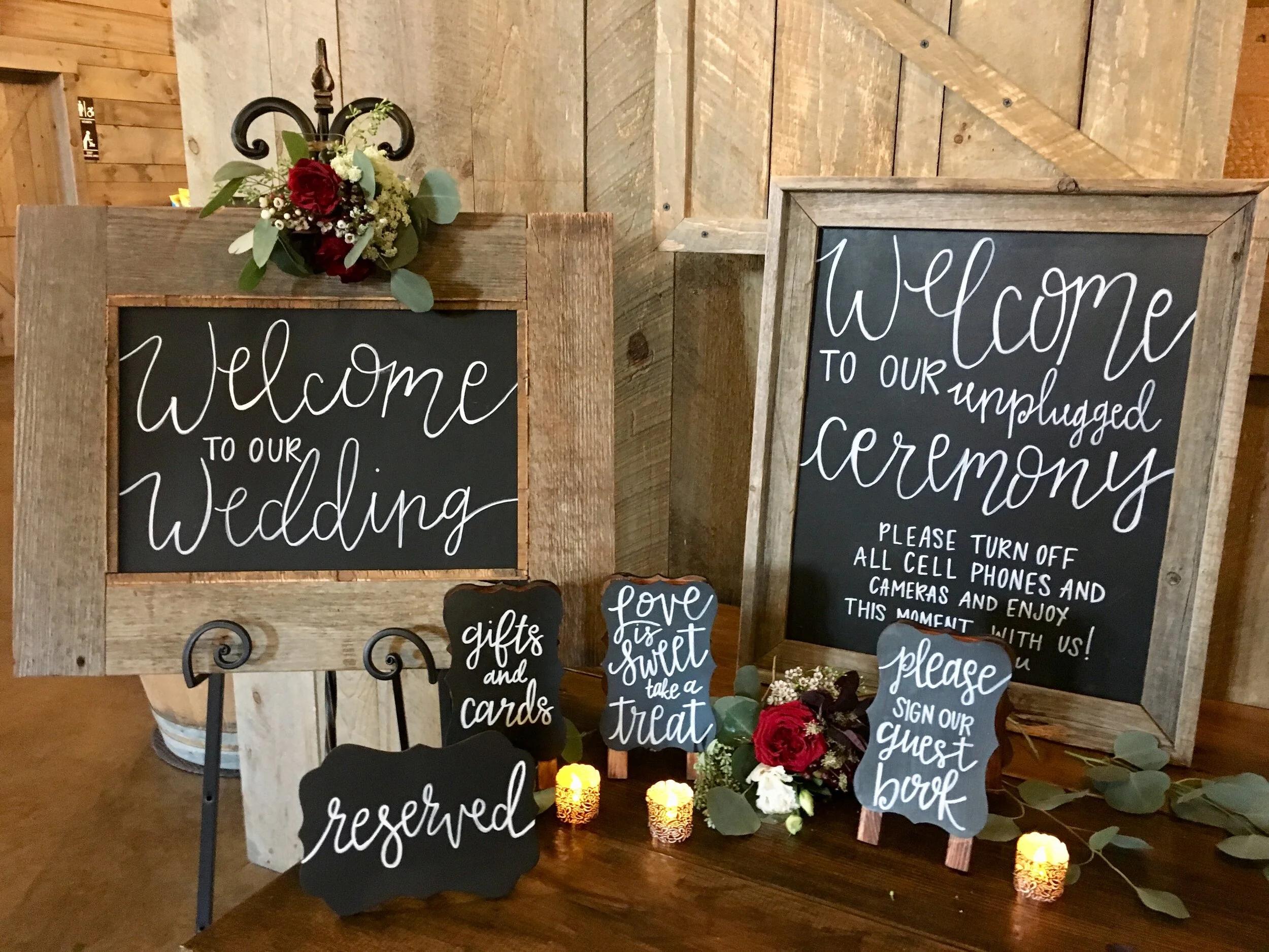 DIY rustic wedding signage displayed with floral accents