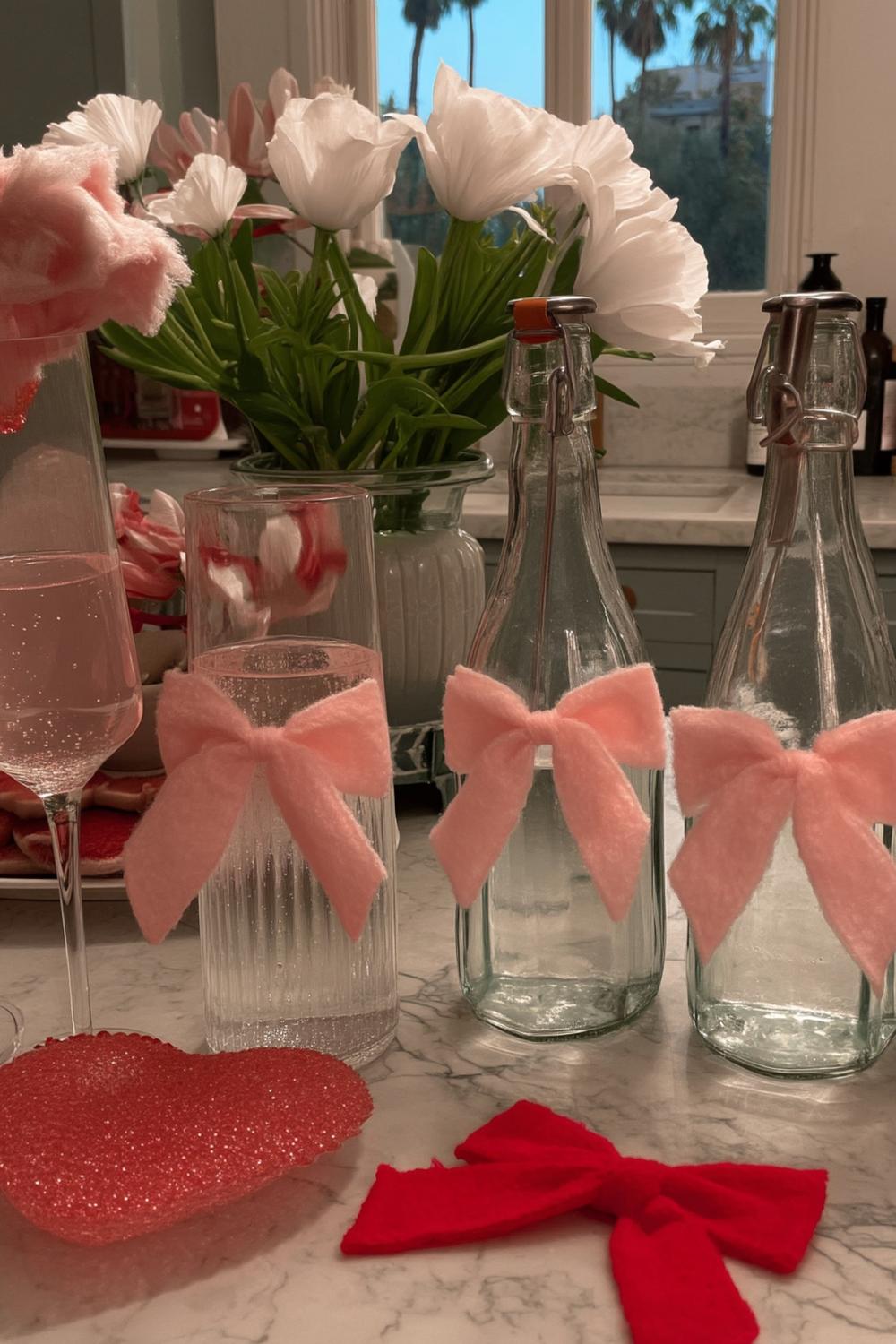 15. Upcycled Bottle Vases with Satin Bows for galentines party decorations diy ideas