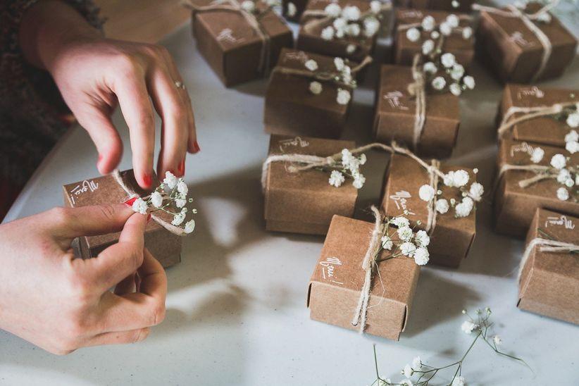Handmade wedding favor boxes decorated with flowers and twine
