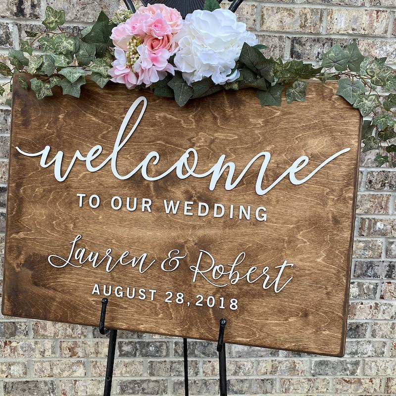 Handmade wooden wedding welcome sign with floral details