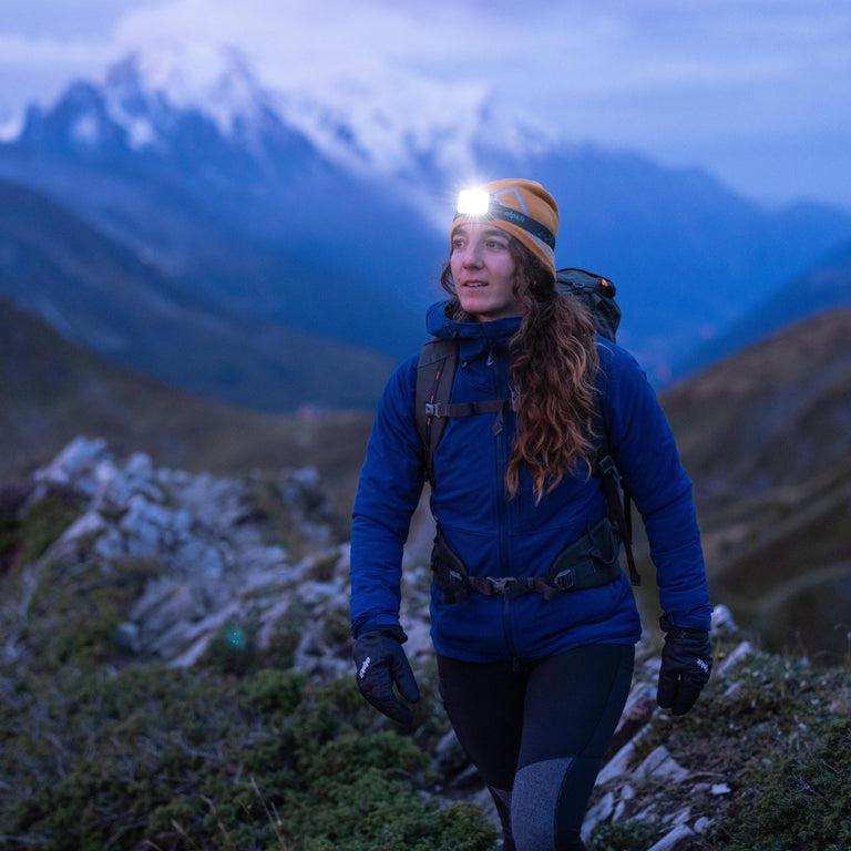 Woman wearing headlamp on trail