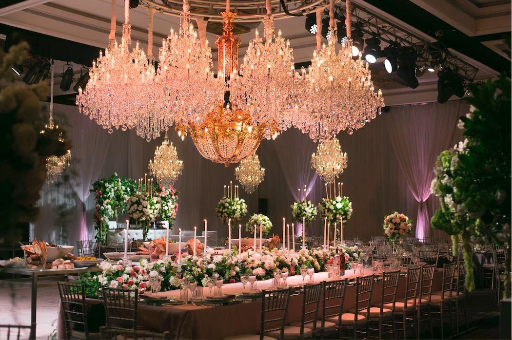 Luxury wedding reception decorations with chandeliers and flowers