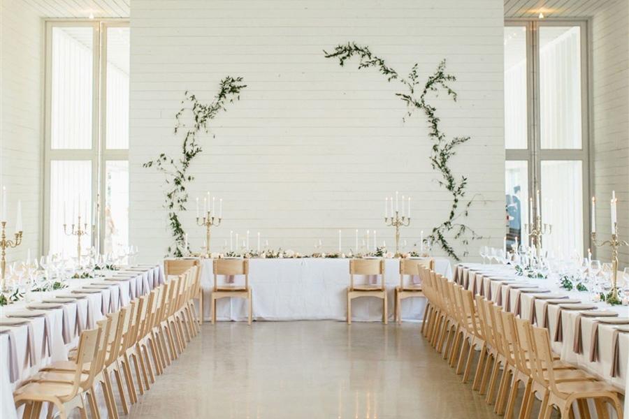 Rustic wedding reception decorations with greenery tables