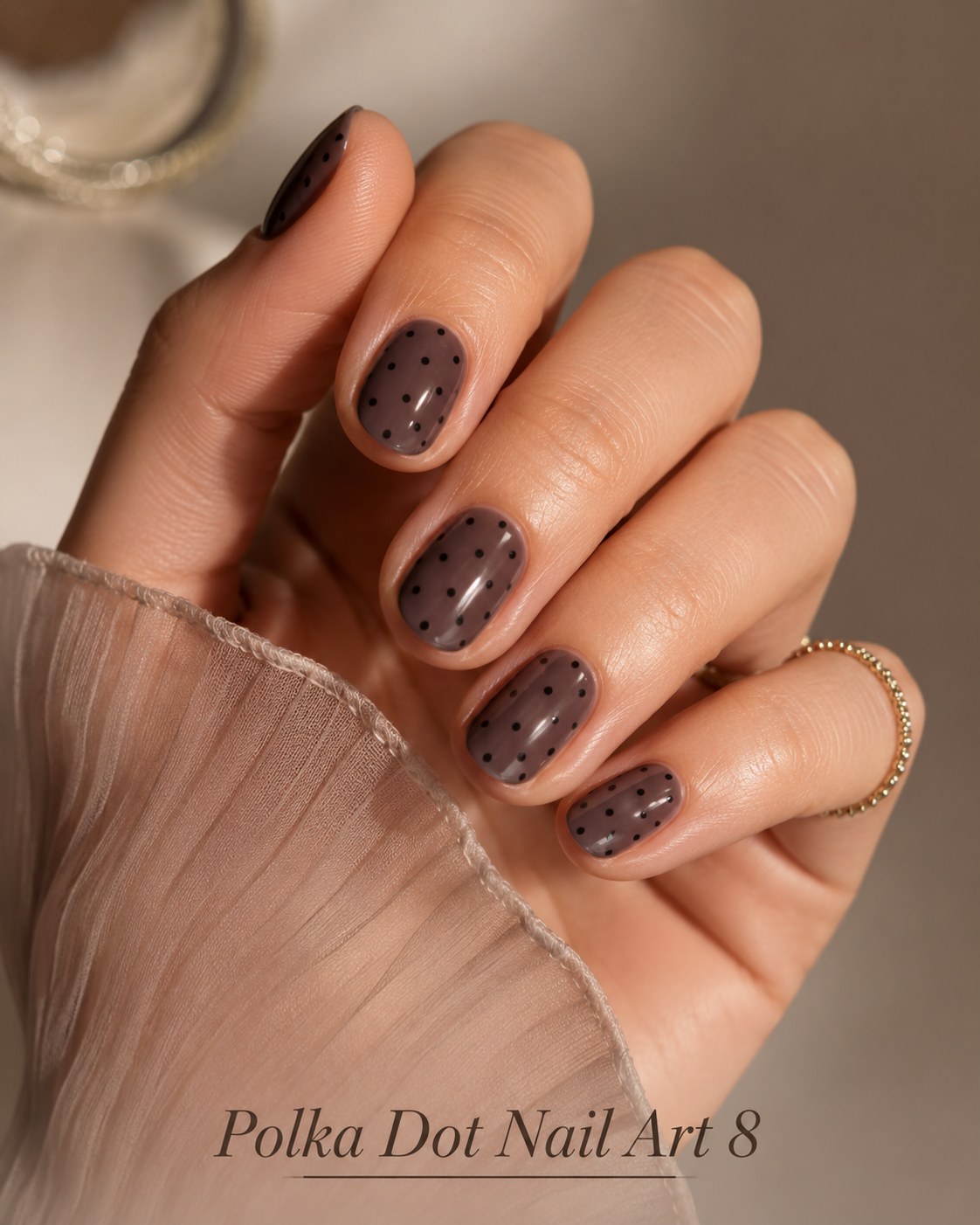 Matte mauve polka dot nail art with fine black dots for a moody evening manicure
