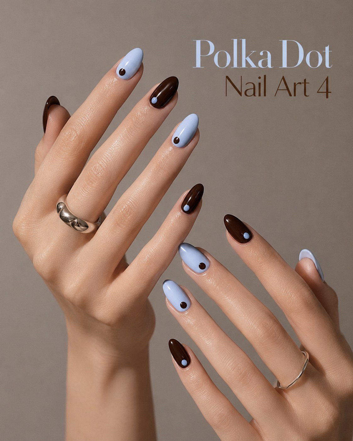 Two-tone brown and blue polka dot nail art with a single accent dot on each nail