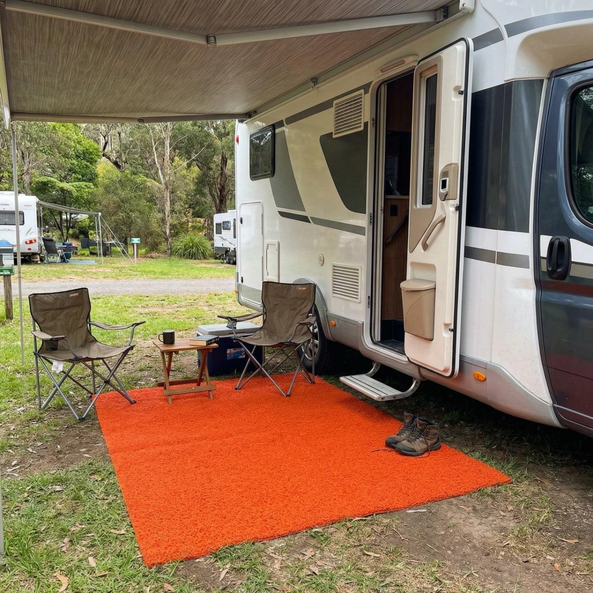RV outdoor mat beside camper