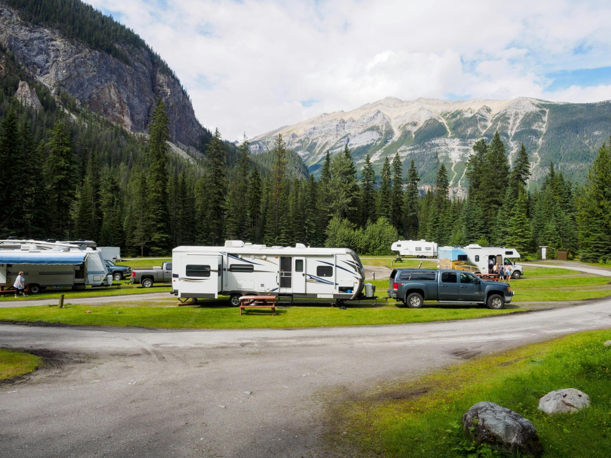 RV campsite in mountains showing affordable outdoor living
