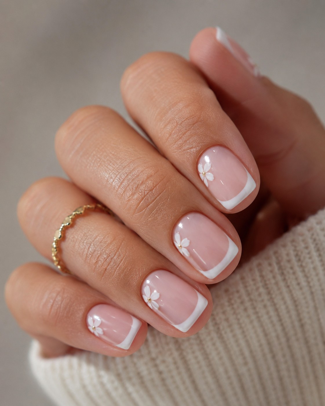 Classic short french tip nails with crisp white tips and a delicate bow accent nail