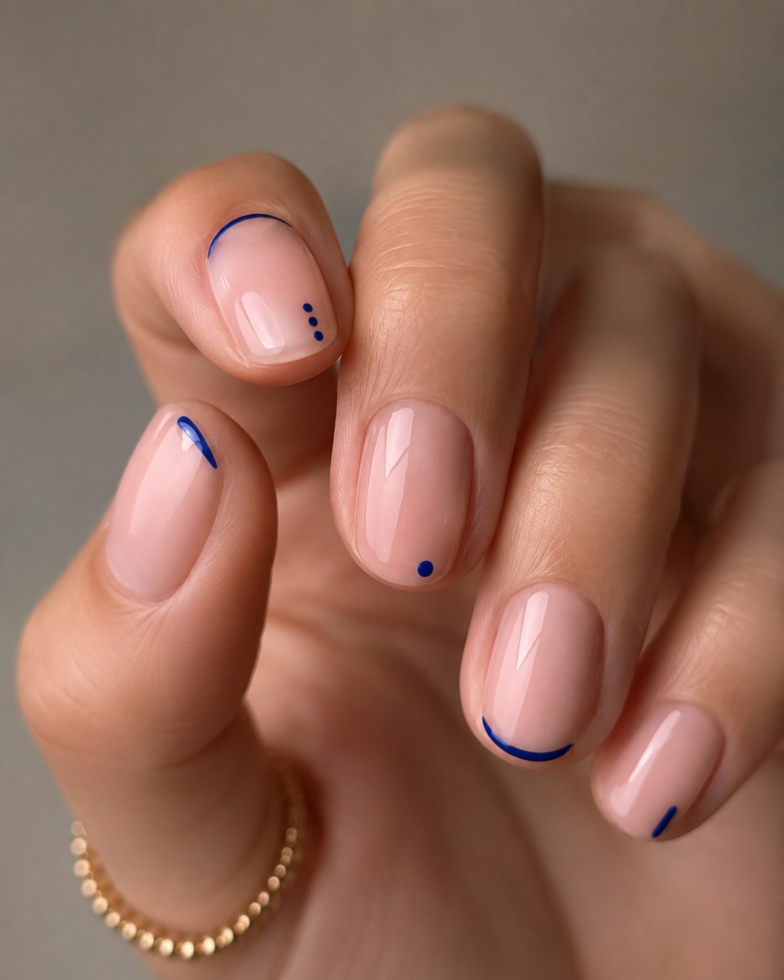Short french tip nails reimagined with navy blue line art and dots for a modern twist