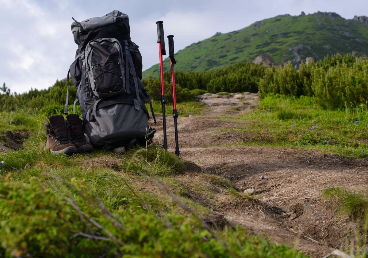 Trekking poles beside hiking backpack