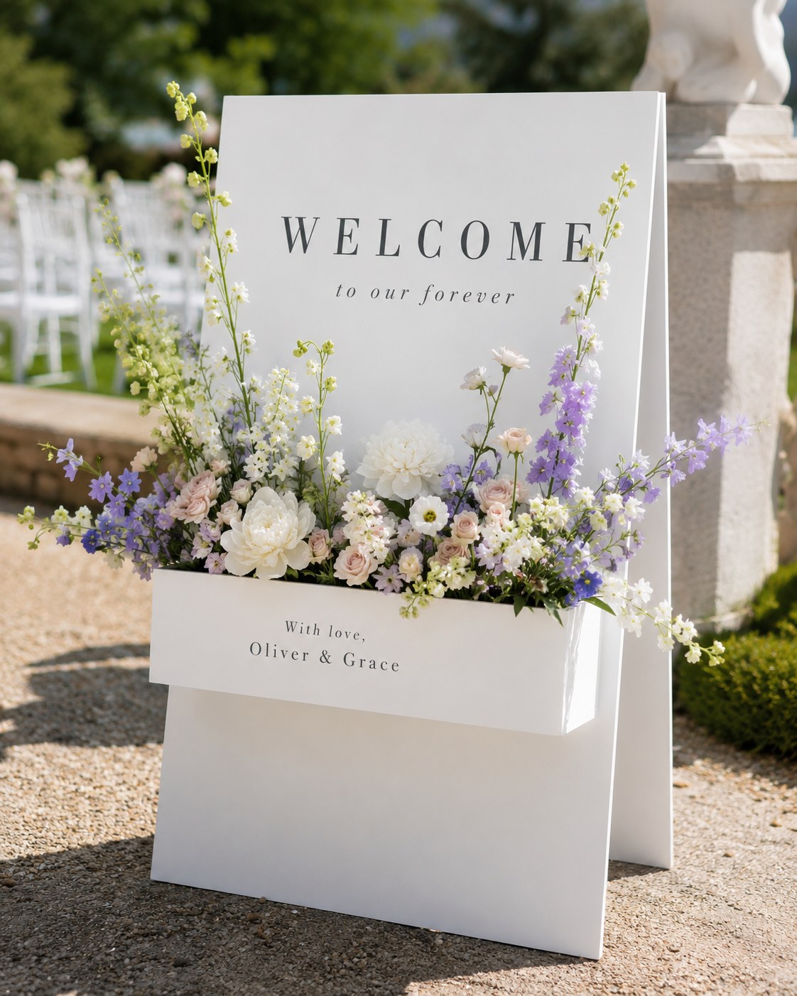 Wildflower-filled welcome sign marks the wedding welcome area along a garden ceremony path